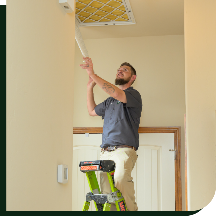 An Emerald technician making adjustments to the air quality system