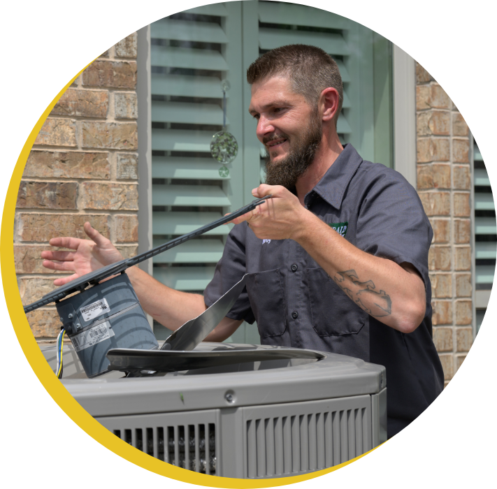 An Emerald Heat and Air HVAC repairman fixing an HVAC unit